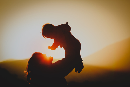 123919172-mother-and-little-baby-play-at-sunset-nature